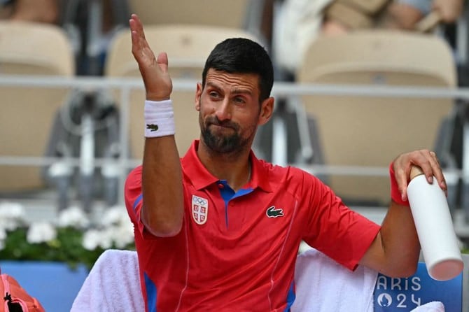 serbia s novak djokovic reacts during a break in play against germany s dominik koepfer during their men s singles third round tennis match on court philippe chatrier at the roland garros stadium at the paris 2024 olympic games on july 31 2024 photo afp