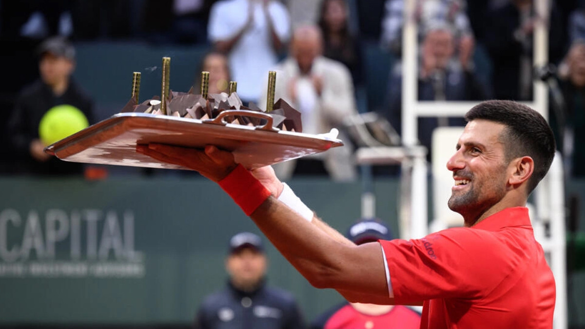 birthday boy novak djokovic lifted his birthday cake to the crowd after winning his first match at the geneva open photo afp