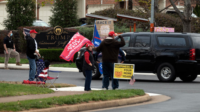 supporters of and protesters against outgoing president donald trump watch his motorcade pass into the trump international golf club in sterling virginia on saturday photo afp supporters of and protesters against outgoing president donald trump watch his motorcade pass into the trump international golf club in sterling virginia on saturday photo afp