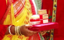 an indian bengali bride women holding dowry for her husband photo shutterstock