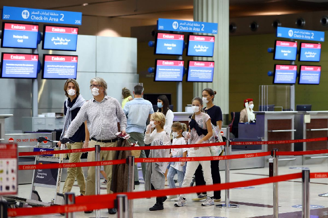 a family walks at dubai international airport as emirates airline resumed limited outbound passenger flights amid outbreak of the coronavirus disease covid 19 in dubai uae april 27 2020 photo reuters