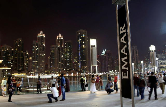 people have their pictures taken near an emaar sign outside the dubai mall march 15 2014 photo reuters people have their pictures taken near an emaar sign outside the dubai mall march 15 2014 photo reuters