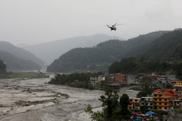 a nepali army helicopter flies above the swollen melamchi river during a rescue mission in sindhupalchok nepal june 16 2021 photo reuters a nepali army helicopter flies above the swollen melamchi river during a rescue mission in sindhupalchok nepal june 16 2021 photo reuters