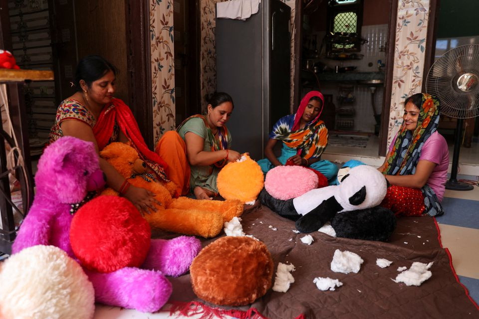 women workers make soft toys using recycled fibre separated from cigarette filter tips at a cigarette butts recycling factory in noida india september 12 2022 reuters