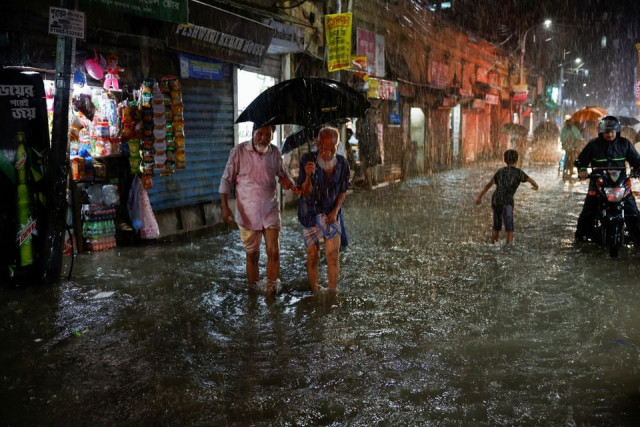 people wade through a flooded street amid continuous rain before the cyclone sitrang hits the country in dhaka bangladesh october 24 2022 reuters people wade through a flooded street amid continuous rain before the cyclone sitrang hits the country in dhaka bangladesh october 24 2022 reuters