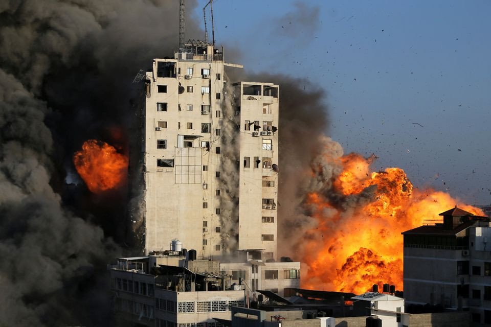 smoke and flames rise from a tower building as it is destroyed by israeli air strikes amid a flare up of israeli palestinian violence in gaza city photo reuters