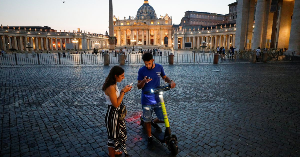 people use their smartphones to rent an electric scooter near st peter s square in rome italy september 18 2020 picture taken september 18 2020 photo reuters