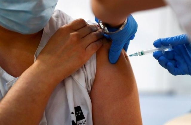 a health worker receives a dose of the pfizer biontech covid 19 vaccine in madrid spain february 4 2021 photo reuters