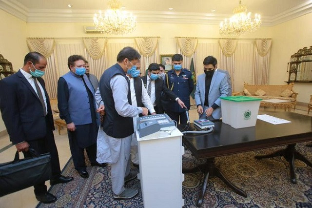 prime minister imran khan inspecting the newly developed electronic voting machine evm in islamabad on aug 8 2021 photo twitter imrankhanpti