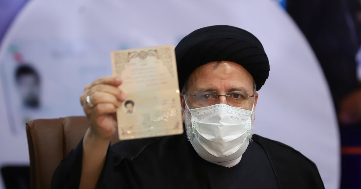 ebrahim raisi chief justice of iran shows his identification document as he registers as a candidate for the presidential election at the interior ministry in tehran iran may 15 2021 photo reuters