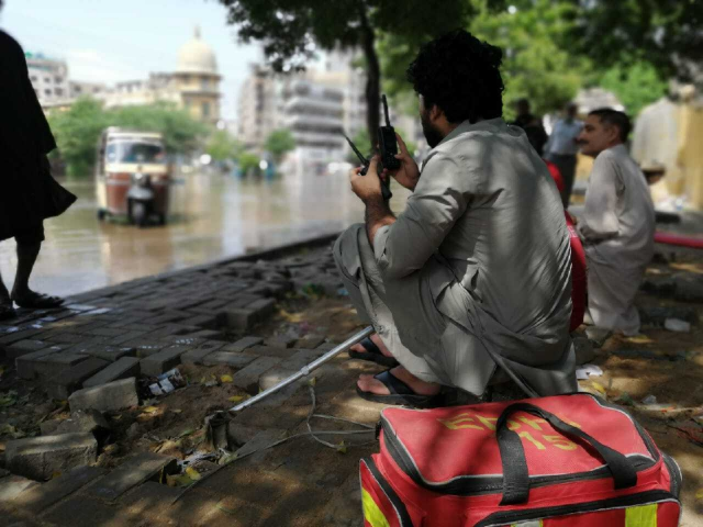following the thunderstorms edhi workers set up a makeshift office on the footpaths next to the flooded street photo express following the thunderstorms edhi workers set up a makeshift office on the footpaths next to the flooded street photo express