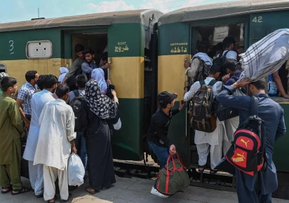 people board a train at the lahore railway station as they return home ahead of eidul azha photo nni