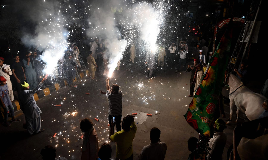 Youth play with fireworks during the celebrations for Eid Miladun Nabi in Lahore on October 18. PHOTO: AFP