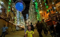 a girl with balloons walks on the eve of eid miladun nabi in karachi october 18 photo reuters