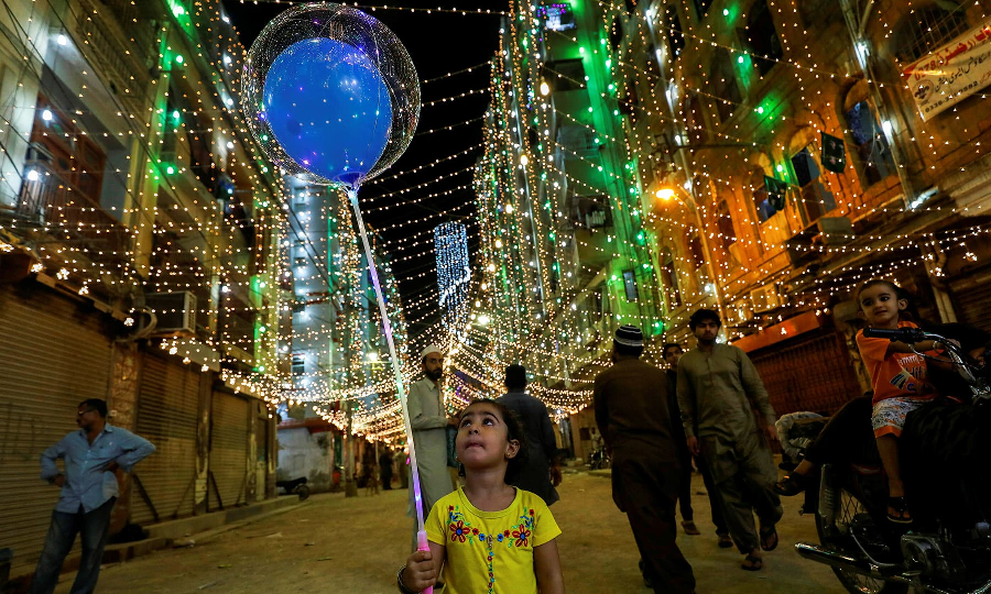 A girl with balloons walks on the eve of Eid Miladun Nabi in Karachi, October 18. PHOTO: REUTERS