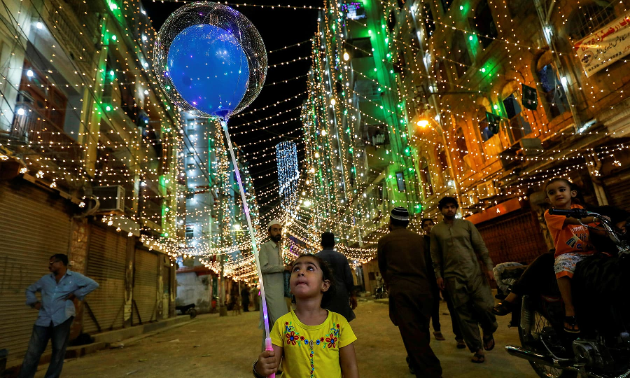 a girl with balloons walks on the eve of eid miladun nabi in karachi october 18 photo reuters