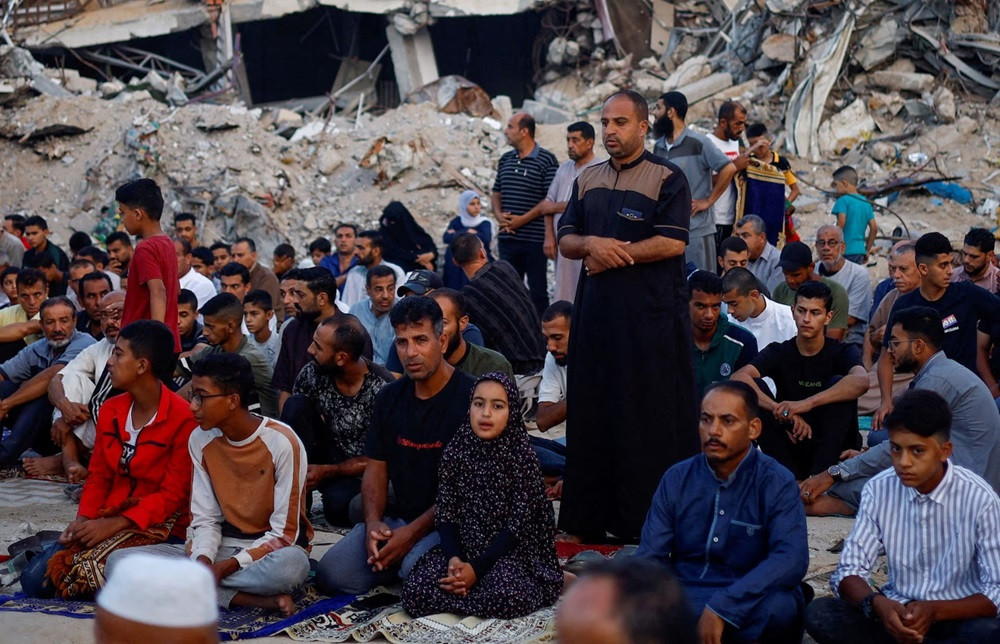 Palestinians hold Eid al-Adha prayers by the ruins of al-Al Rahma mosque destroyed by Israeli air strikes, in Khan Younis, in the southern Gaza Strip. PHOTO: REUTERS
