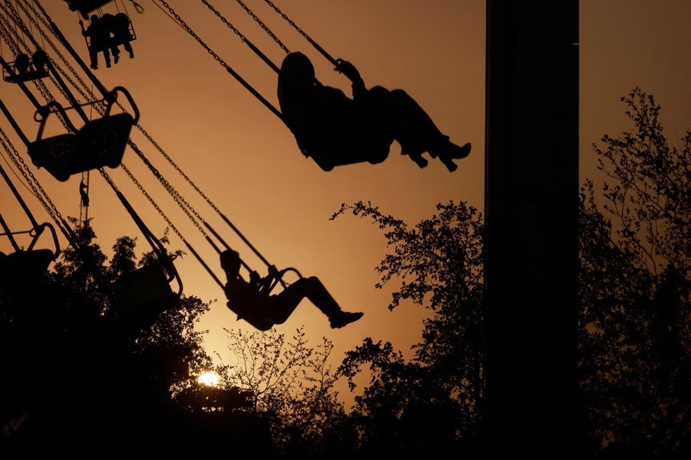 Iraqi residents take a ride at an amusement park as they celebrate the Muslim festival of Eidul Azha in Baghdad, Iraq. PHOTO: REUTERS