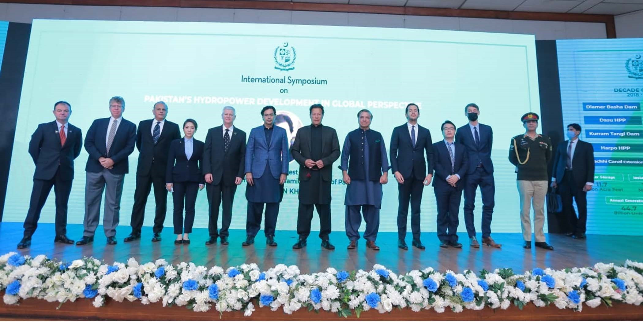 pm imran khan and federal minister for water resources moonis elahi in a group photo with experts of the international symposium on pakistan s hydropower development in global perspective in islamabad on feb 14 2022 photo pid