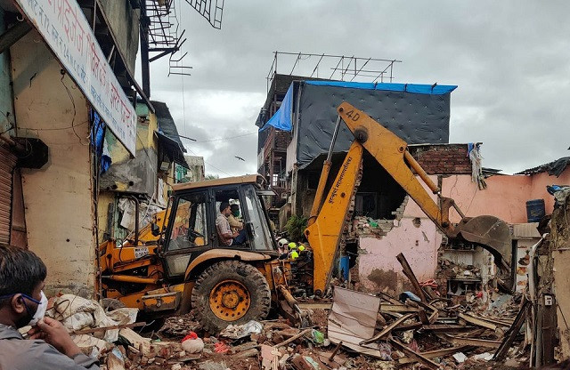 rescue workers search for survivors in the debris after a residential building collapsed in mumbai india june 10 2021 photo reuters