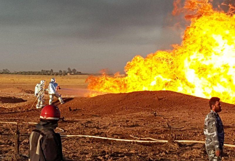 firefighters spray water on the fire that resulted from an explosion on the arab gas pipeline between the towns of ad dumayr and adra northwest of the capital of damascus syria in this handout released by sana on august 24 2020 photo reuters