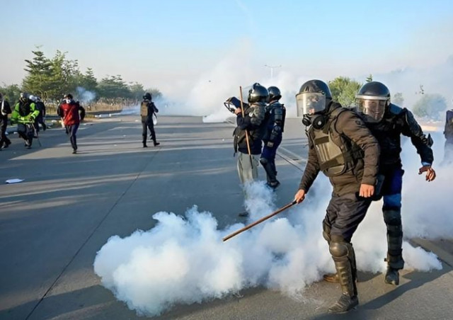 policemen fire tear gas shells to disperse supporters of pakistan tehreek e insaf pti party during a protest to demand the release of former prime minister imran khan in islamabad on november 26 2024 afp