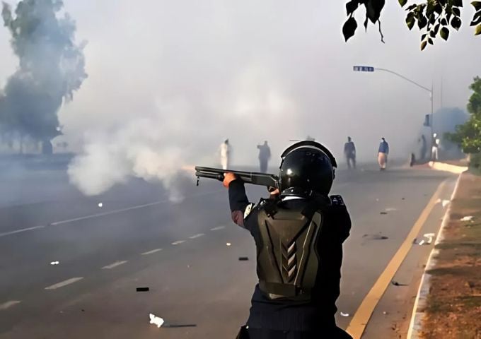 a policeman fires rubber bullets to disperse supporters of the pakistan tehreek e insaf party in islamabad afp