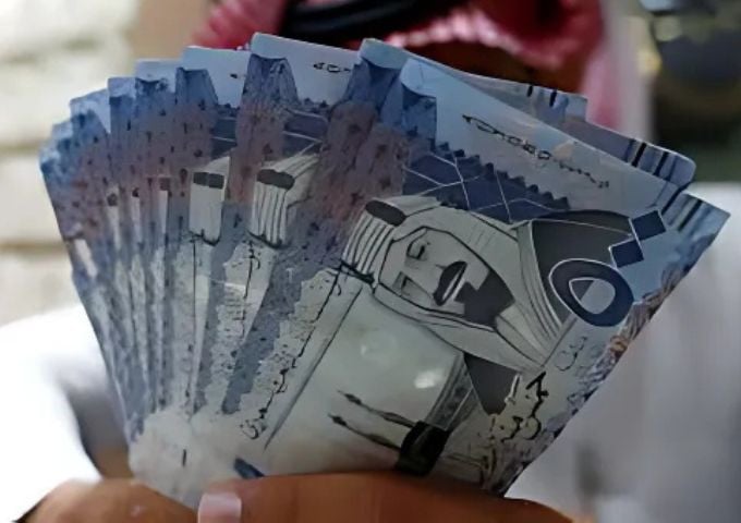 saudi money changer displays saudi riyal banknotes at a currency exchange shop in riyadh saudi arabia photo reuters