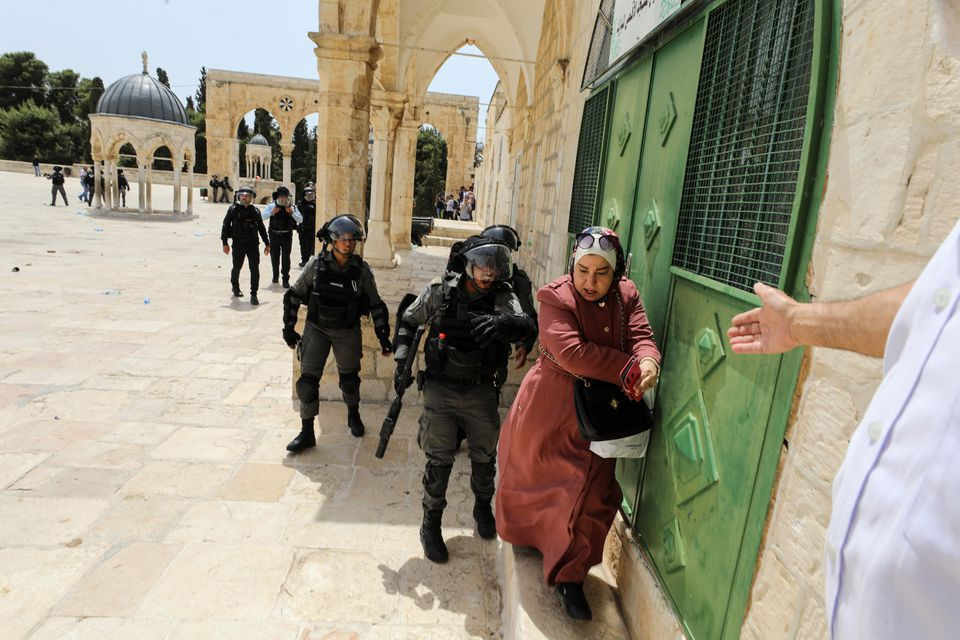 israeli border policeman shouts on a palestinian woman at the compound that houses al aqsa mosque known to muslims as noble sanctuary and to jews as temple mount in jerusalem s old city may 21 2021 photo reuters