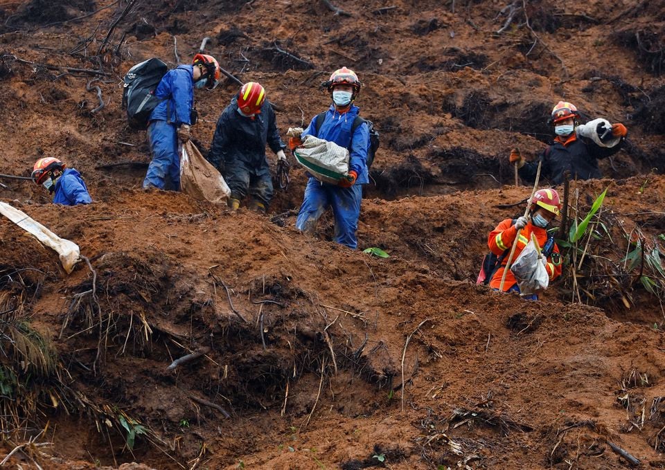 rescue workers work at the site where a china eastern airlines boeing 737 800 plane flying from kunming to guangzhou crashed in wuzhou guangxi zhuang autonomous region china march 24 2022 reuters