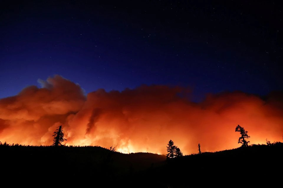 Photo of Year's largest fire burns through dry terrain to destroy California homes