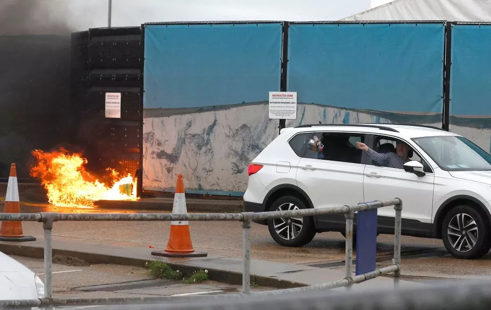 a man throws an object out of a car window next to the border force centre after a firebomb attack in dover britain october 30 2022 photo reuters a man throws an object out of a car window next to the border force centre after a firebomb attack in dover britain october 30 2022 photo reuters
