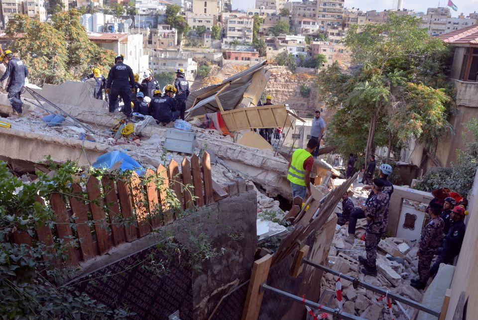 civil defence members search for survivors at the site of a four storey residential building collapse in amman jordan september 14 2022 reuters