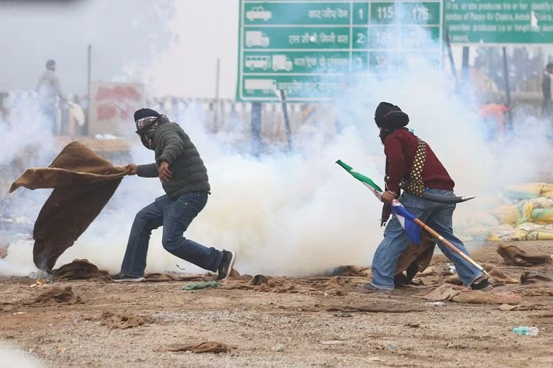 a farmer reacts as tear gas is fired at farmers marching toward the indian capital february 21 2024 photo reuters