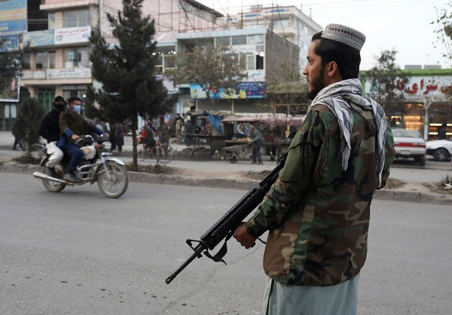 A Taliban fighter stands guard at the site of a blast in Kabul, Afghanistan, November 17, 2021. PHOTO: REUTERS