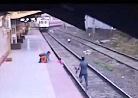 cctv image of mayur shelke s incredible rescue of grabbing the boy throwing him back onto the platform and then climbing up himself barely two seconds before the udyan express thundered through screengrab