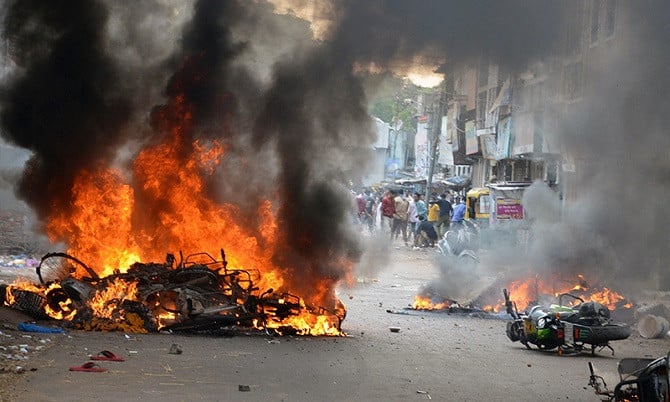 vehicles being burnt during a communal conflict in vadadora gujarat photo reuters