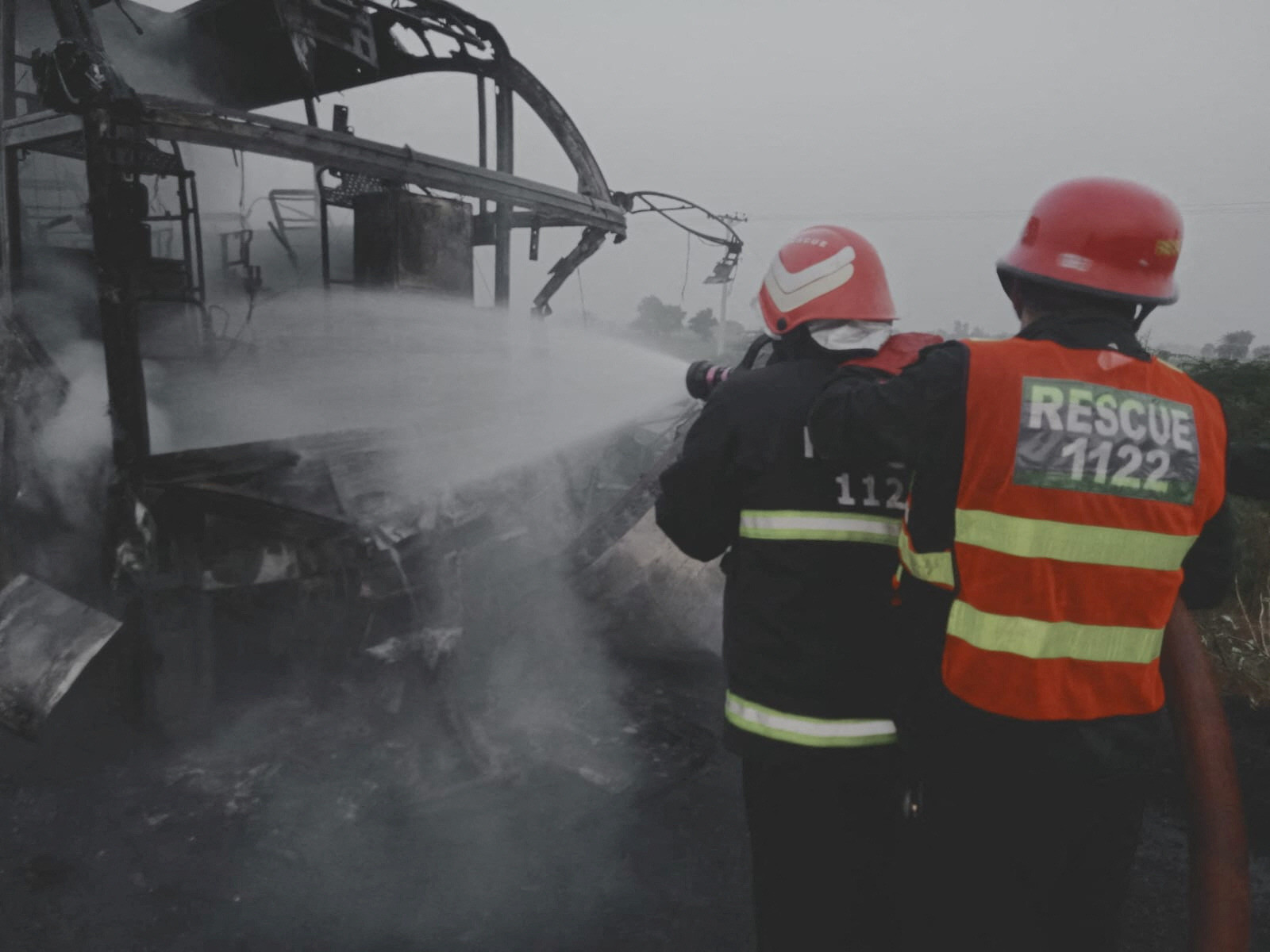 rescuers douse a fire on a bus near pindi bhattian photo reuters