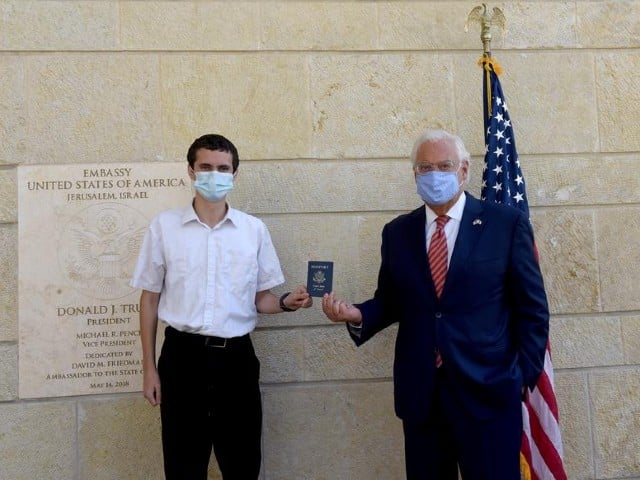 us ambassador to israel david friedman presents menachem zivotofsky a us citizen who was born in jerusalem his passport that lists israel as birthplace at the us embassy in jerusalem october 30 2020 photo reuters