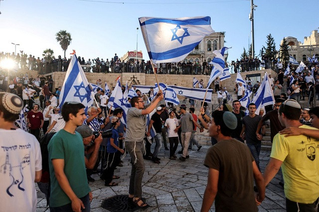 israelis dance with flags by damascus gate just outside jerusalem s old city june 15 2021 photo reuters