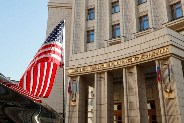 a flag is seen on the us delegation s car which is parked in front of the headquarters of the russian foreign ministry after us under secretary of state victoria nuland arrived for talks with russian officials in moscow russia october 12 2021 photo reuters