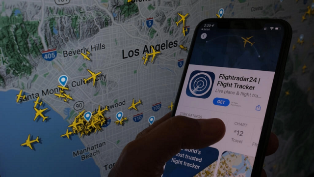 the flightradar24 app is seen on a smartphone in front of a screen showing the live position of planes tracked by the app in the area of los angeles on august 5 2022 photo afp the flightradar24 app is seen on a smartphone in front of a screen showing the live position of planes tracked by the app in the area of los angeles on august 5 2022 photo afp