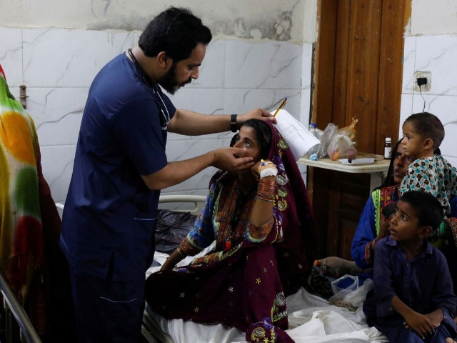 naveed ahmed 30 a doctor gives medical assistance to flood affected girl hameeda 15 suffering from malaria at sayed abdullah shah institute of medical sciences in sehwan pakistan september 29 2022 reuters akhtar soomro