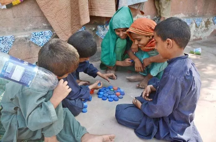 children of flood affected families sheltered in relief camp at government comprehensive higher secondary school no 1 korangi karachi playing with used bottle caps photo app children of flood affected families sheltered in relief camp at government comprehensive higher secondary school no 1 korangi karachi playing with used bottle caps photo app