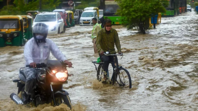 in new delhi commuters battled through knee deep waters photo afp in new delhi commuters battled through knee deep waters photo afp