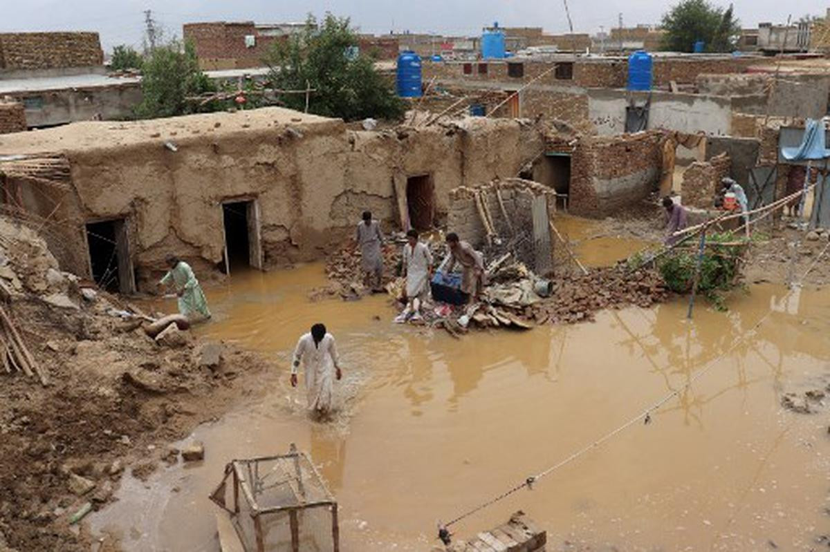residents clear debris of a damaged house due to a heavy monsoon rainfall on the outskirts of quetta balochistan pakistan on july 5 2022 photo afp