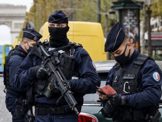 french police officers control a car on the champs elysee avenue in paris on october 30 2020 photo afp