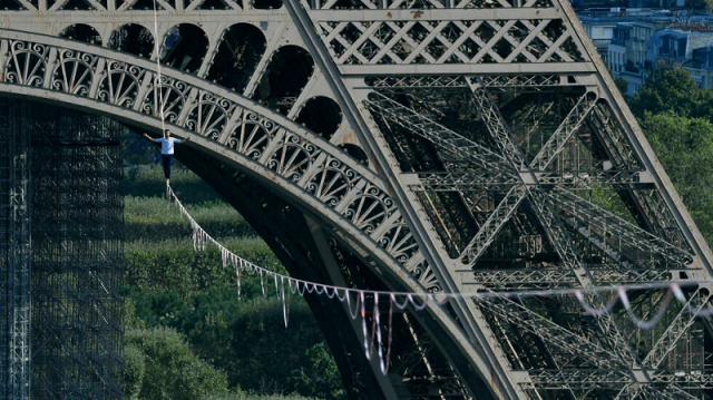 attached by a strap to a safety lanyard 27 year old nathan paulin slowly progressed barefoot on a line stretched across the river photo afp attached by a strap to a safety lanyard 27 year old nathan paulin slowly progressed barefoot on a line stretched across the river photo afp