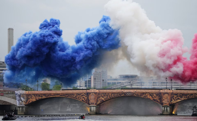 smoke clouds in the tricolours of the france flag are seen at pont d austerlitz during the opening ceremony of the paris 2024 olympics july 26 2024 photo reuters