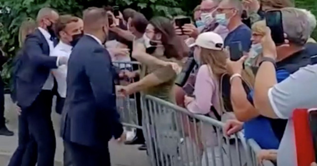 french president emmanuel macron gets slapped by a member of the public during a visit in tain l hermitage france in this still image taken from video on june 8 2021 photo reuters french president emmanuel macron gets slapped by a member of the public during a visit in tain l hermitage france in this still image taken from video on june 8 2021 photo reuters